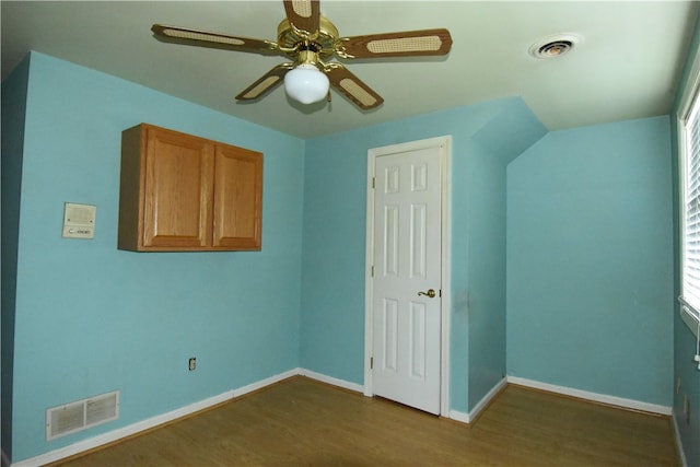 interior space with ceiling fan and dark hardwood / wood-style floors