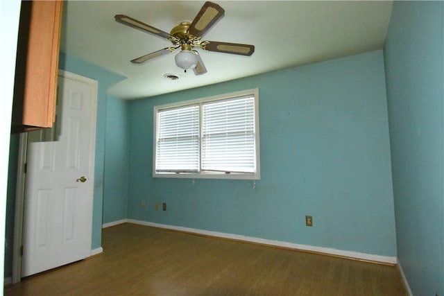 empty room featuring hardwood / wood-style flooring and ceiling fan