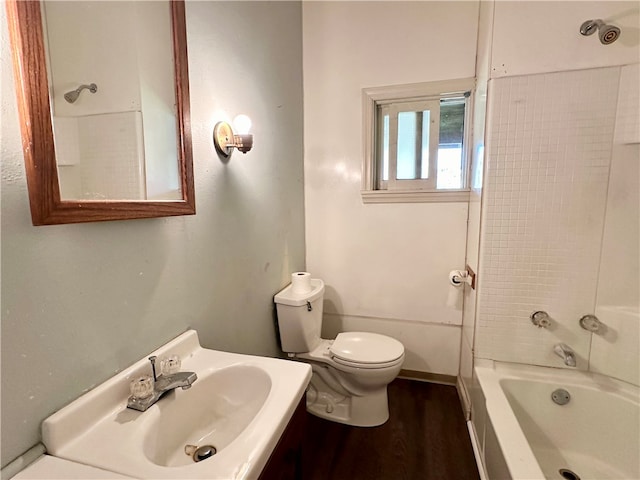 full bathroom with tub / shower combination, vanity, toilet, and wood-type flooring