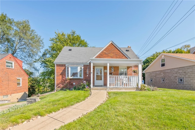 bungalow with covered porch and a front yard