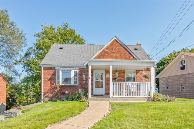 bungalow featuring a porch and a front lawn