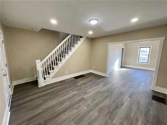 unfurnished living room featuring dark wood-type flooring