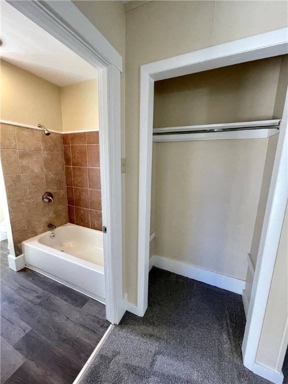 bathroom with hardwood / wood-style floors and tiled shower / bath combo