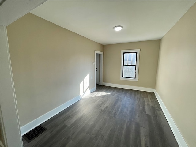 unfurnished room featuring dark hardwood / wood-style floors