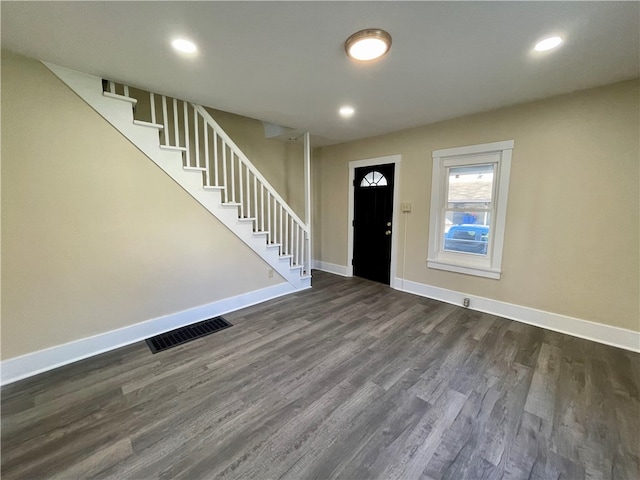 entryway with dark hardwood / wood-style flooring