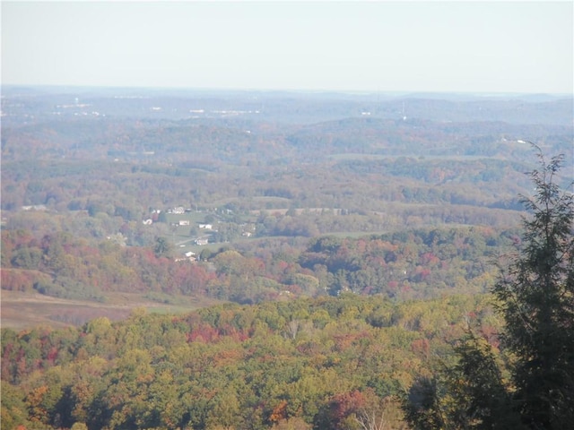 birds eye view of property with a wooded view