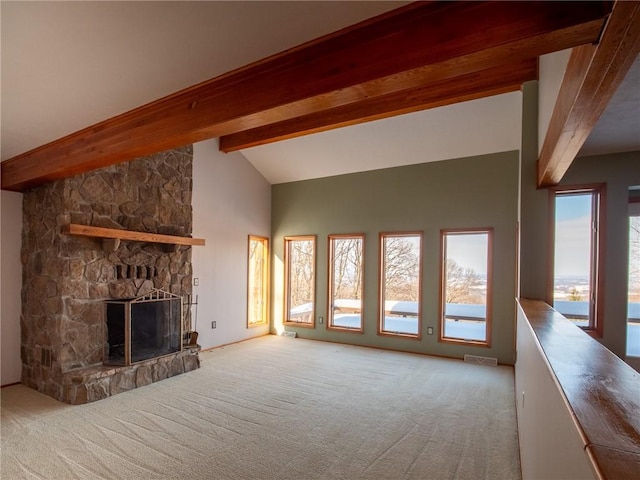 unfurnished living room featuring visible vents, carpet floors, a fireplace, high vaulted ceiling, and beam ceiling