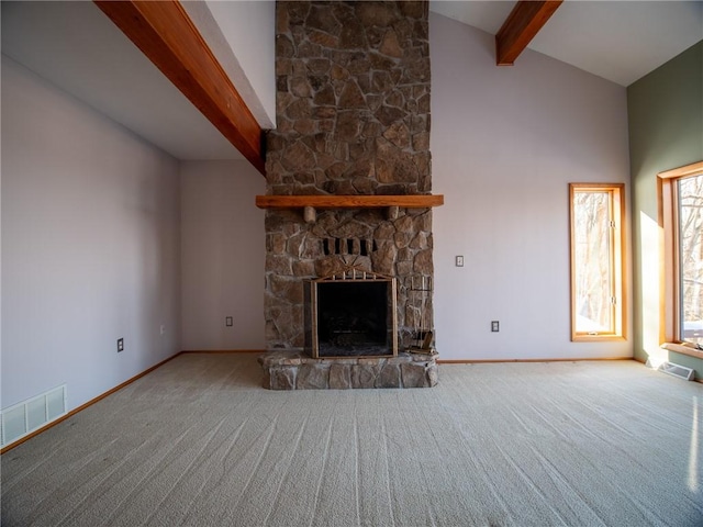 unfurnished living room featuring visible vents, carpet, a fireplace, high vaulted ceiling, and beam ceiling