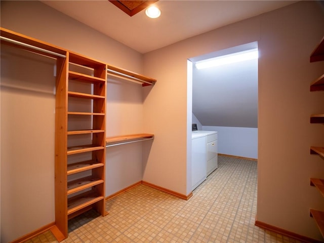 walk in closet with washer and clothes dryer and light floors