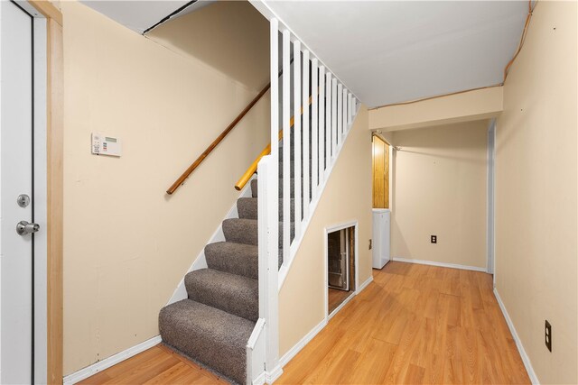 stairway with hardwood / wood-style flooring