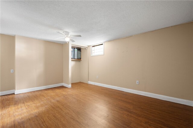 basement with hardwood / wood-style floors and a textured ceiling