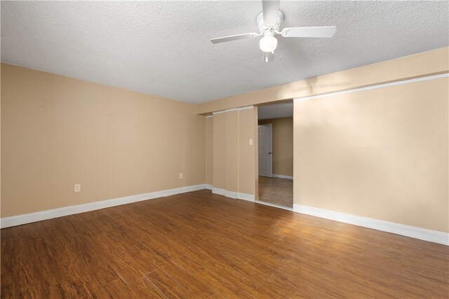 spare room featuring ceiling fan, wood-type flooring, and a textured ceiling