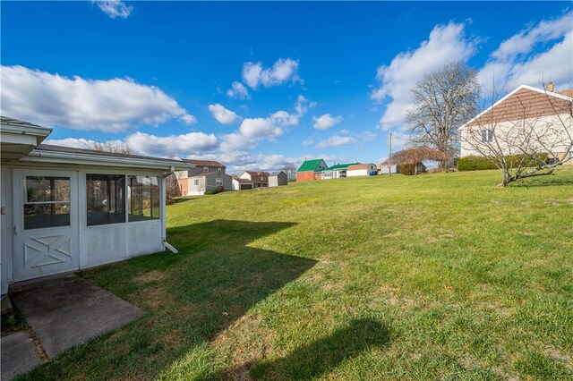 view of yard with a sunroom