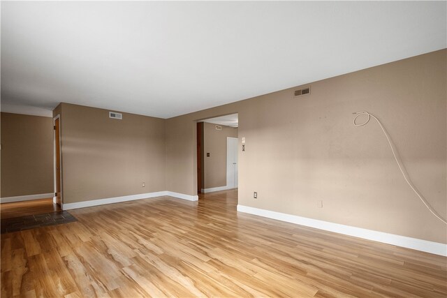 spare room featuring light hardwood / wood-style floors