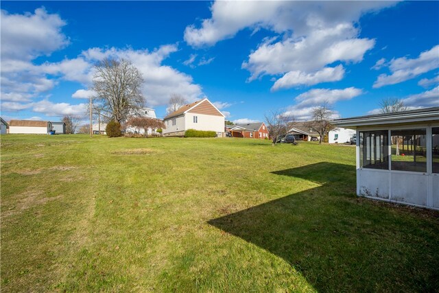 view of yard featuring a sunroom