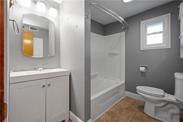 full bathroom featuring tile patterned flooring, bathtub / shower combination, vanity, and toilet