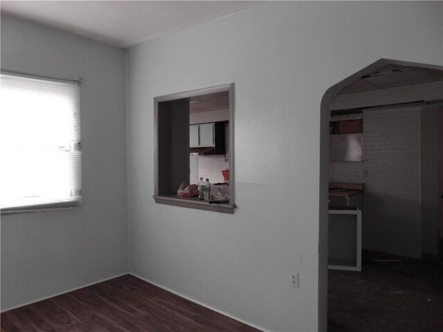 571 2nd St, Pitcairn, PA 15140 - empty room with dark wood-type flooring and arched walkways
