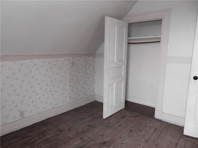 additional living space featuring dark hardwood / wood-style floors and vaulted ceiling