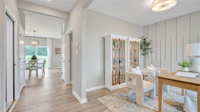 office space featuring a notable chandelier and light wood-type flooring