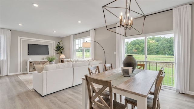 dining area featuring an inviting chandelier and light hardwood / wood-style floors