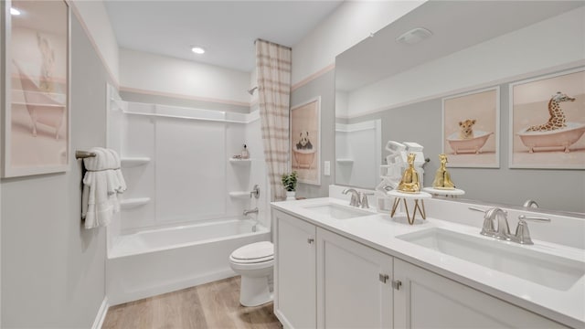 full bathroom with tub / shower combination, hardwood / wood-style flooring, vanity, and toilet