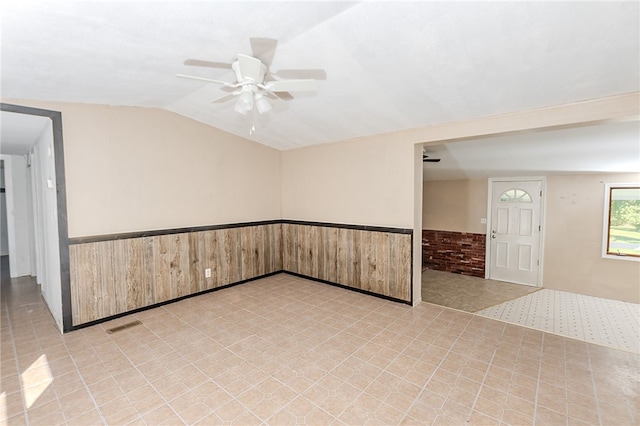 unfurnished room featuring lofted ceiling and ceiling fan