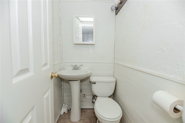 bathroom with toilet and tile patterned flooring