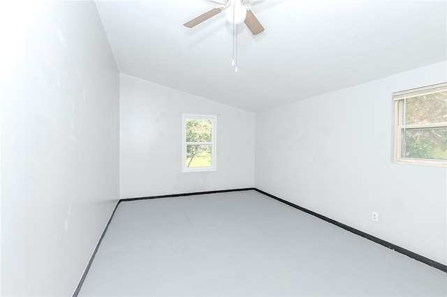 empty room featuring lofted ceiling and ceiling fan