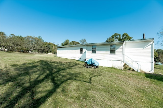 rear view of house with a lawn