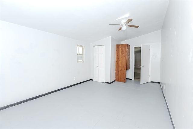 empty room featuring ceiling fan and lofted ceiling