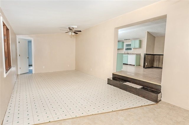 unfurnished room featuring sink and ceiling fan