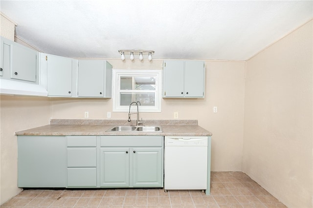 kitchen with sink, dishwasher, and a textured ceiling