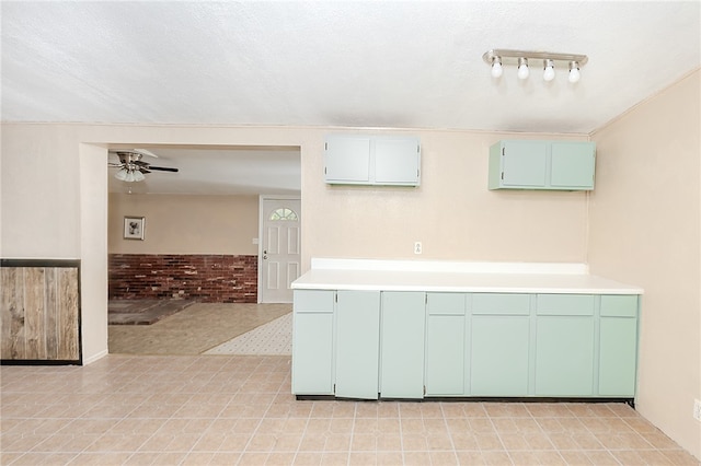 kitchen with a textured ceiling and ceiling fan