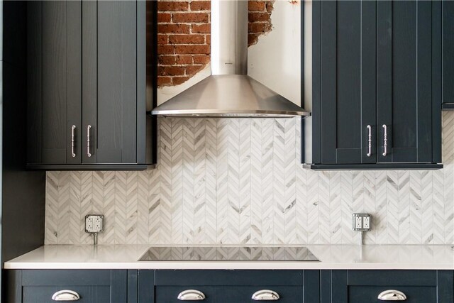 915 Liberty Ave Unit 2, Downtown Pgh, PA 15222 - kitchen featuring wall chimney exhaust hood, black stovetop, light countertops, and backsplash