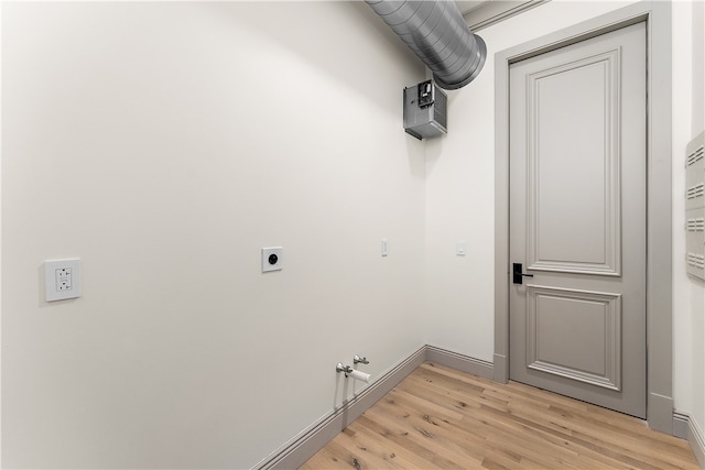 washroom featuring light wood-type flooring, hookup for an electric dryer, and washer hookup