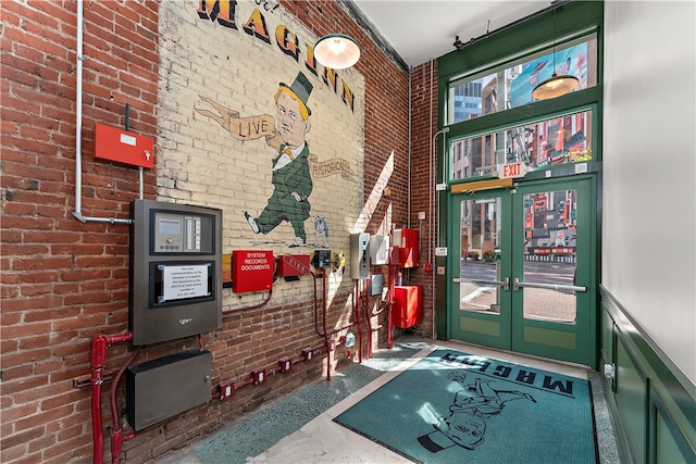 interior space featuring french doors and brick wall