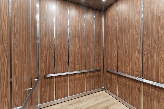 interior details featuring hardwood / wood-style floors and elevator