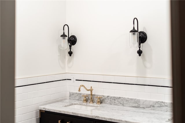 bathroom with vanity and tile walls