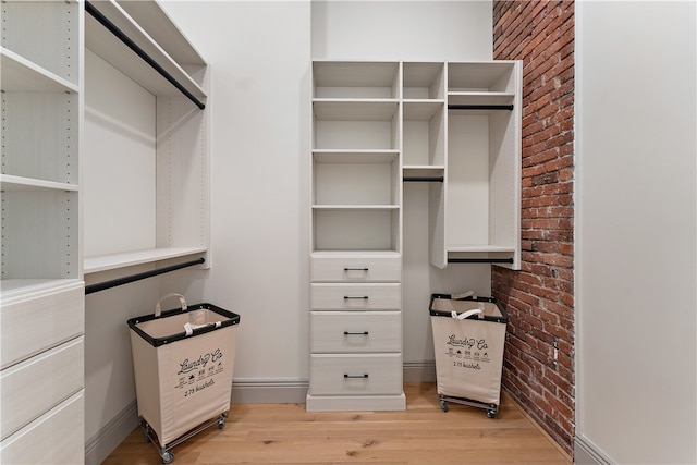 spacious closet with light hardwood / wood-style floors