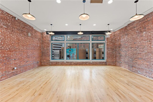 915 Liberty Ave Unit 5, Downtown Pgh, PA 15222 - spare room with wood finished floors, brick wall, and recessed lighting