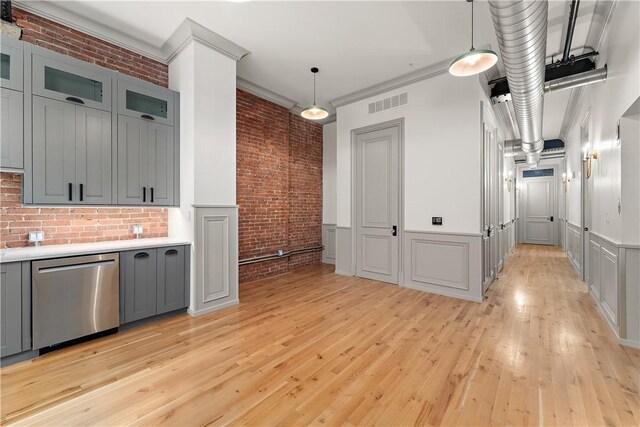 915 Liberty Ave Unit 5, Downtown Pgh, PA 15222 - kitchen with stainless steel dishwasher, brick wall, gray cabinetry, light wood finished floors, and light countertops
