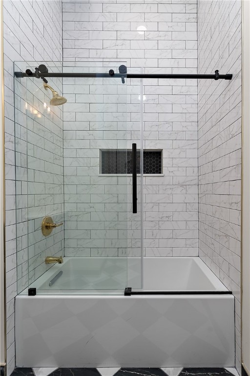 bathroom featuring bath / shower combo with glass door