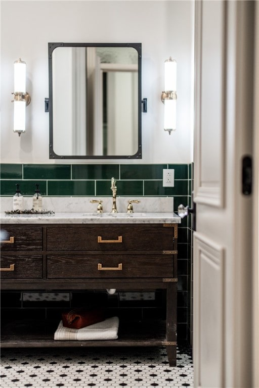 bathroom featuring vanity and backsplash