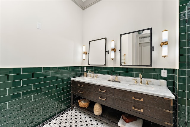 bathroom with tile patterned floors, crown molding, tile walls, and vanity