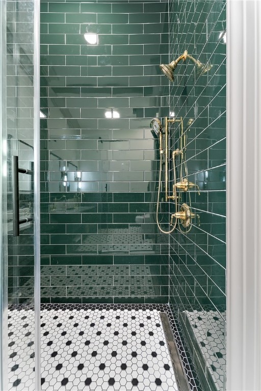 bathroom with a shower with door