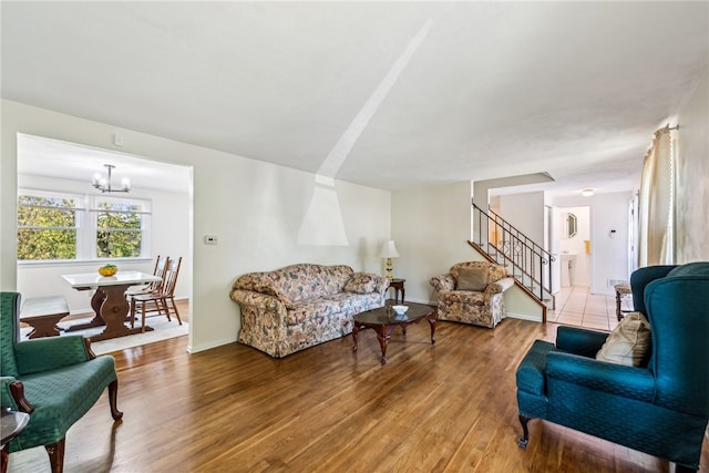 living room with hardwood / wood-style flooring and an inviting chandelier