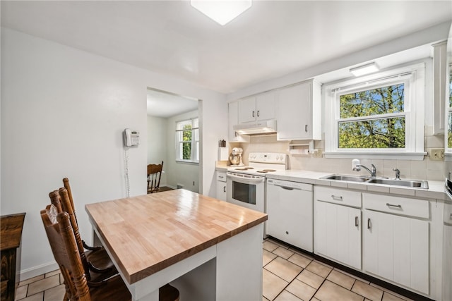 kitchen with backsplash, white cabinetry, sink, and white appliances