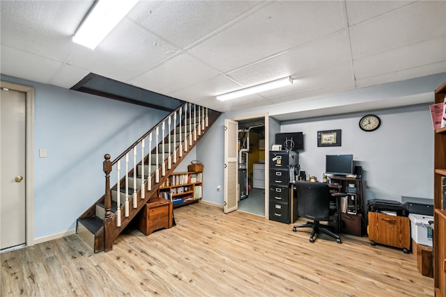 office space featuring a paneled ceiling and light hardwood / wood-style floors