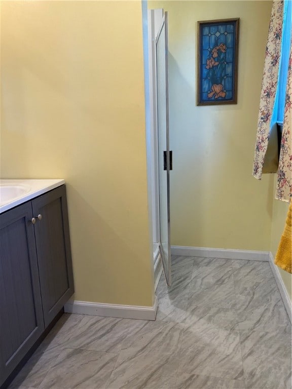 bathroom featuring vanity and an enclosed shower