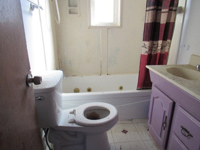 full bathroom featuring tile patterned floors, vanity, toilet, and shower / bathtub combination with curtain